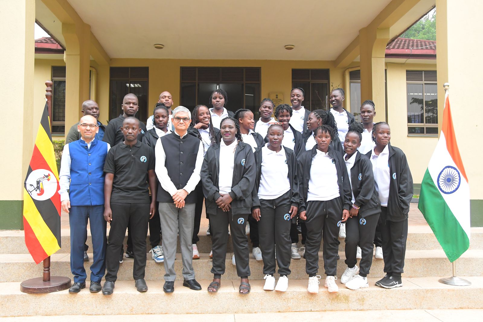 The Uganda Kho Kho team with officials in front of the flags of Uganda and India