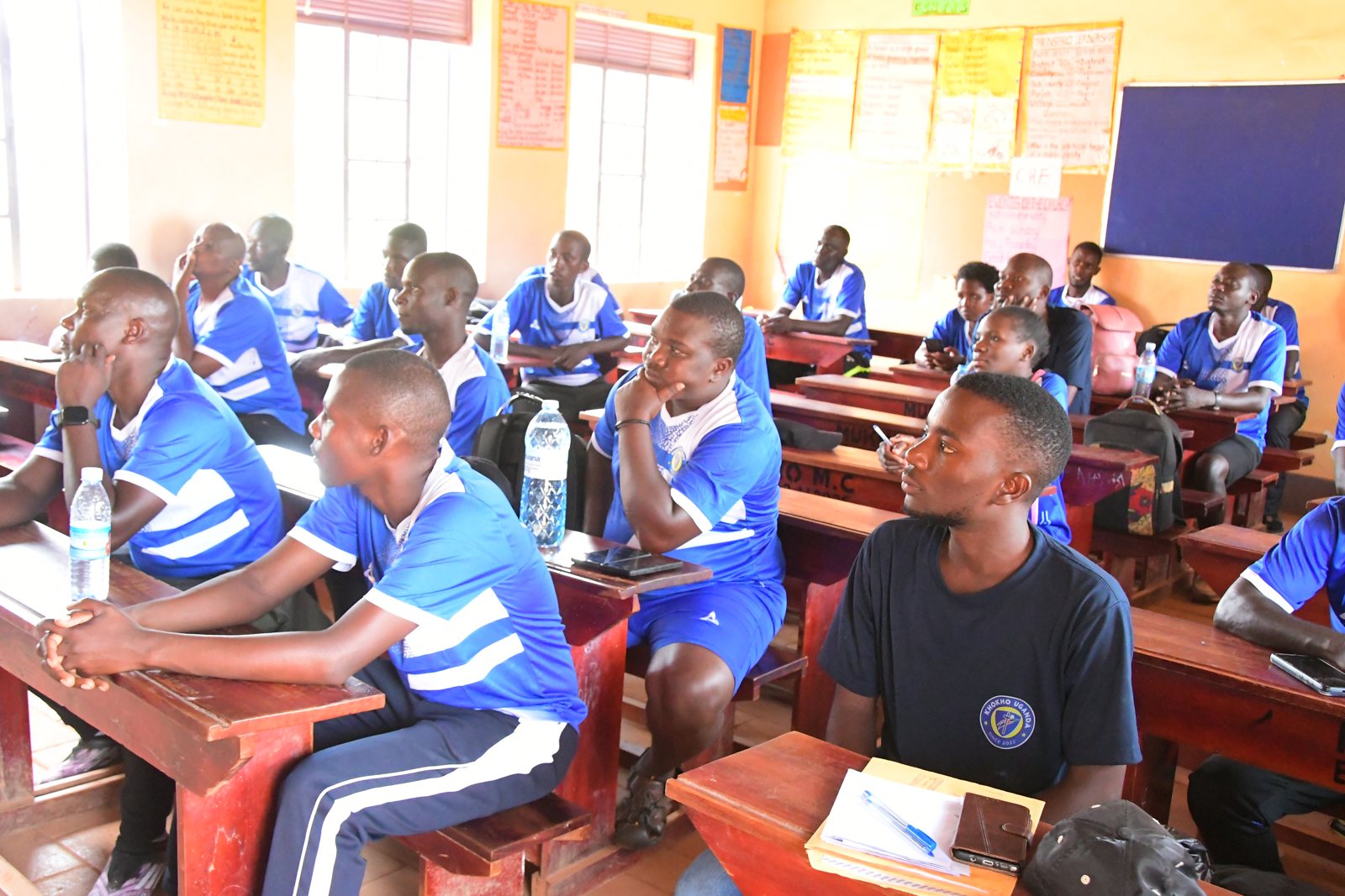 Participants in blue Kho Kho Uganda kit sit at classroom desks during the Level 1 course