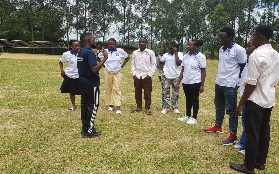 Students and tutors gather around the instructors at Kakyeka