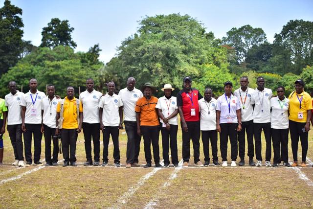 Match officials and teams line up