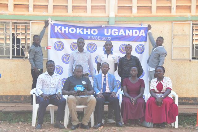 Guests and trainers in front of the banner