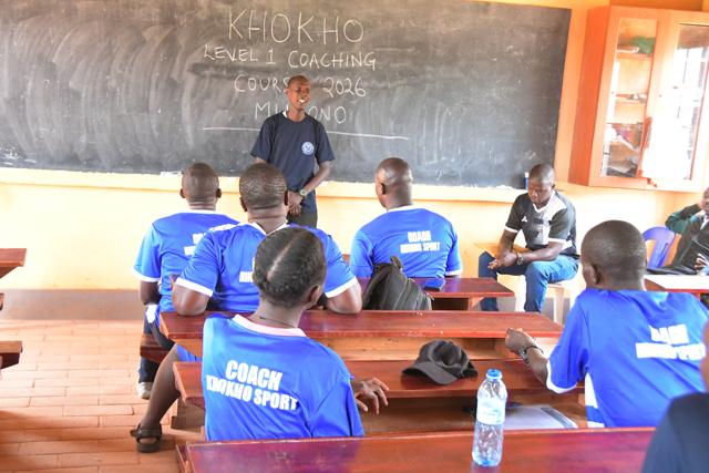 Participants in Kho Kho Uganda course shirts listen to the trainer