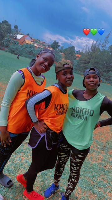 Players in orange bibs pose together