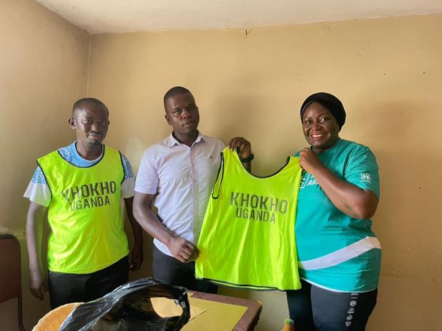 Participants hold Kho Kho Uganda bibs