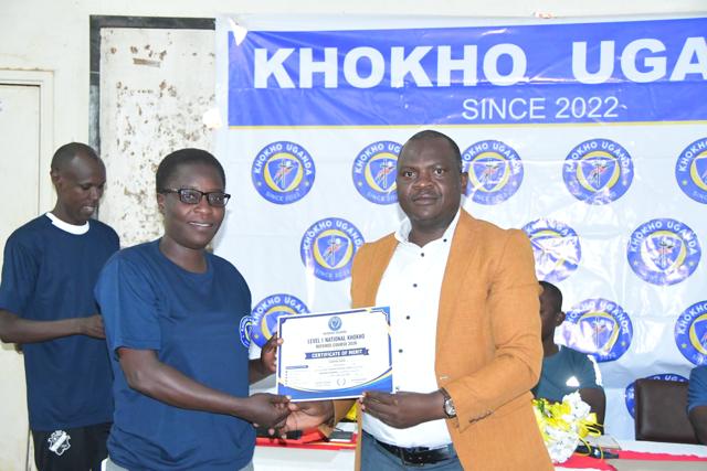 Participants receive certificates at the banner
