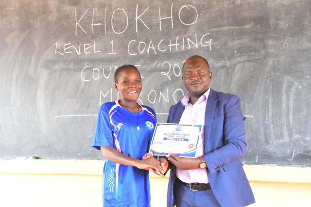A young participant receives her certificate