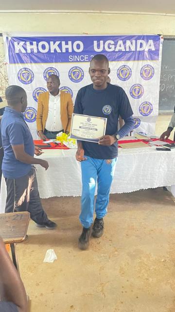 A participant holds his certificate