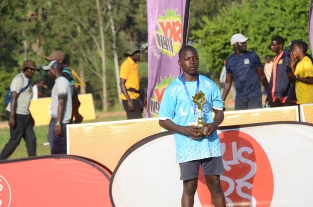 A player in light blue holds a trophy at the Ball Games II awards
