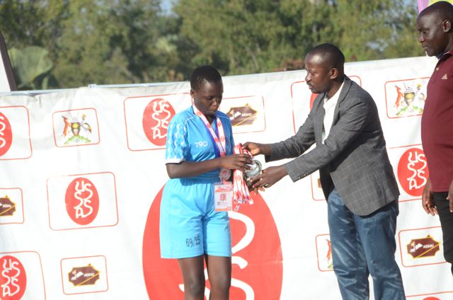 A medal is presented to a player in light blue
